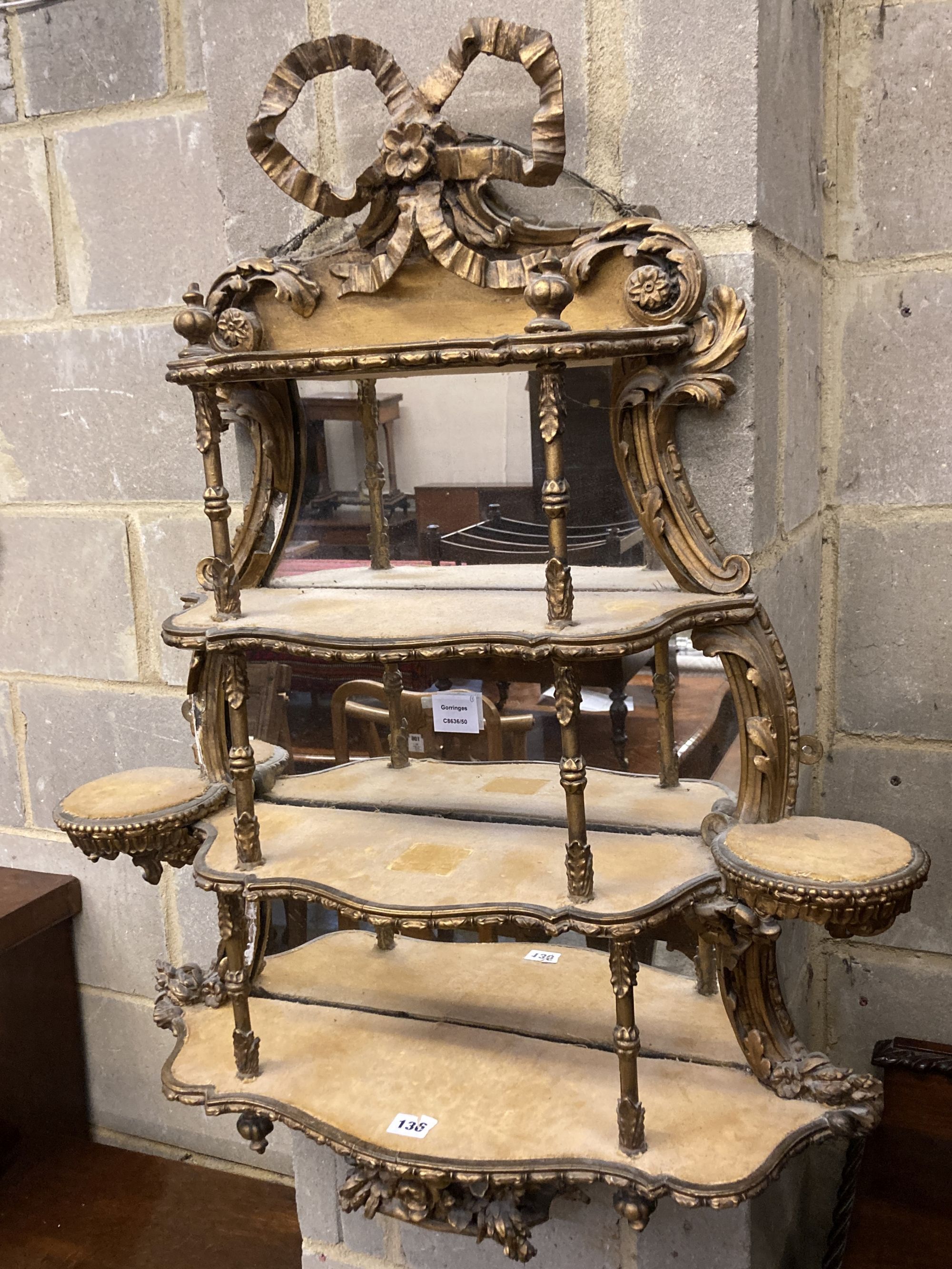 A Victorian gilt carved wood and gesso four tier mirrored bracket, width 70cm, depth 17cm, height 90cm